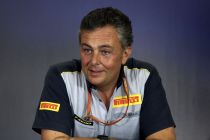 Pirelli motosport boss Mario Isola in a press conference wearing Pirelli team kit