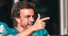 Alonso points finger like a gun, whilst winking!