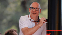 Jacques Villeneuve tapping his security pass to enter the F1 paddock