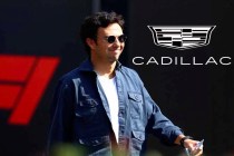 Sergio Perez walking through the F1 paddock with the Cadillac logo behind him