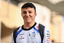 Hadjar of Racing Bulls, F1 driver smiling in his white race suit