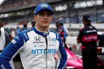 Racing driver in team uniform, poised.