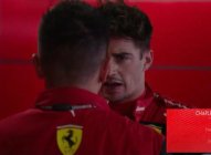 Two Ferrari team members conversing intensely.