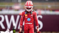 Charles Leclerc, a Ferrari driver walking in his racing suit and helmet