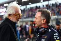 Two men discussing at a race.