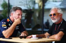 Two men discussing at a table.