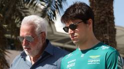 Two men walking in sunny environment.