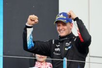 Celebrating victory in racing attire.