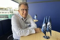 Man sitting at a table with flags.