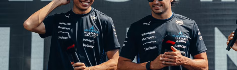 Two racing drivers in team uniforms.