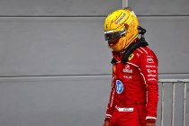 Hamilton looking dejected, walking with his yellow helmet still on in Baku 2025