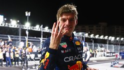 Verstappen holds up 4 fingers to show how many drivers titles he now has, in las vegas