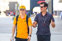 Piastri and manager Mark Webber walk the F1 paddock chatting