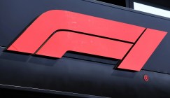 Formula 1 logo in red on the side of a building