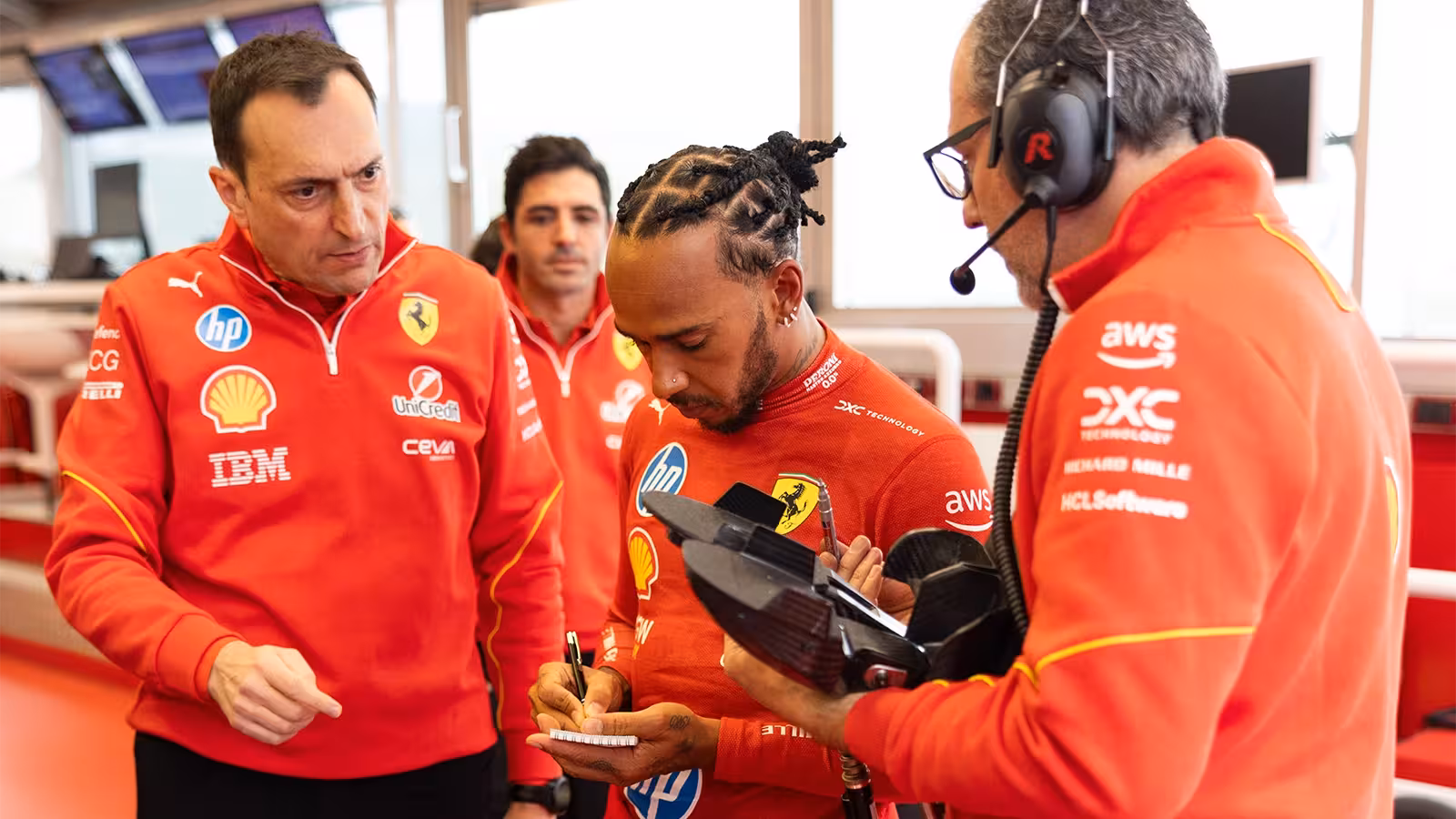 Ferrari engineers with Hamilton