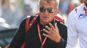 Jean Alesi with red bag and lanyard.