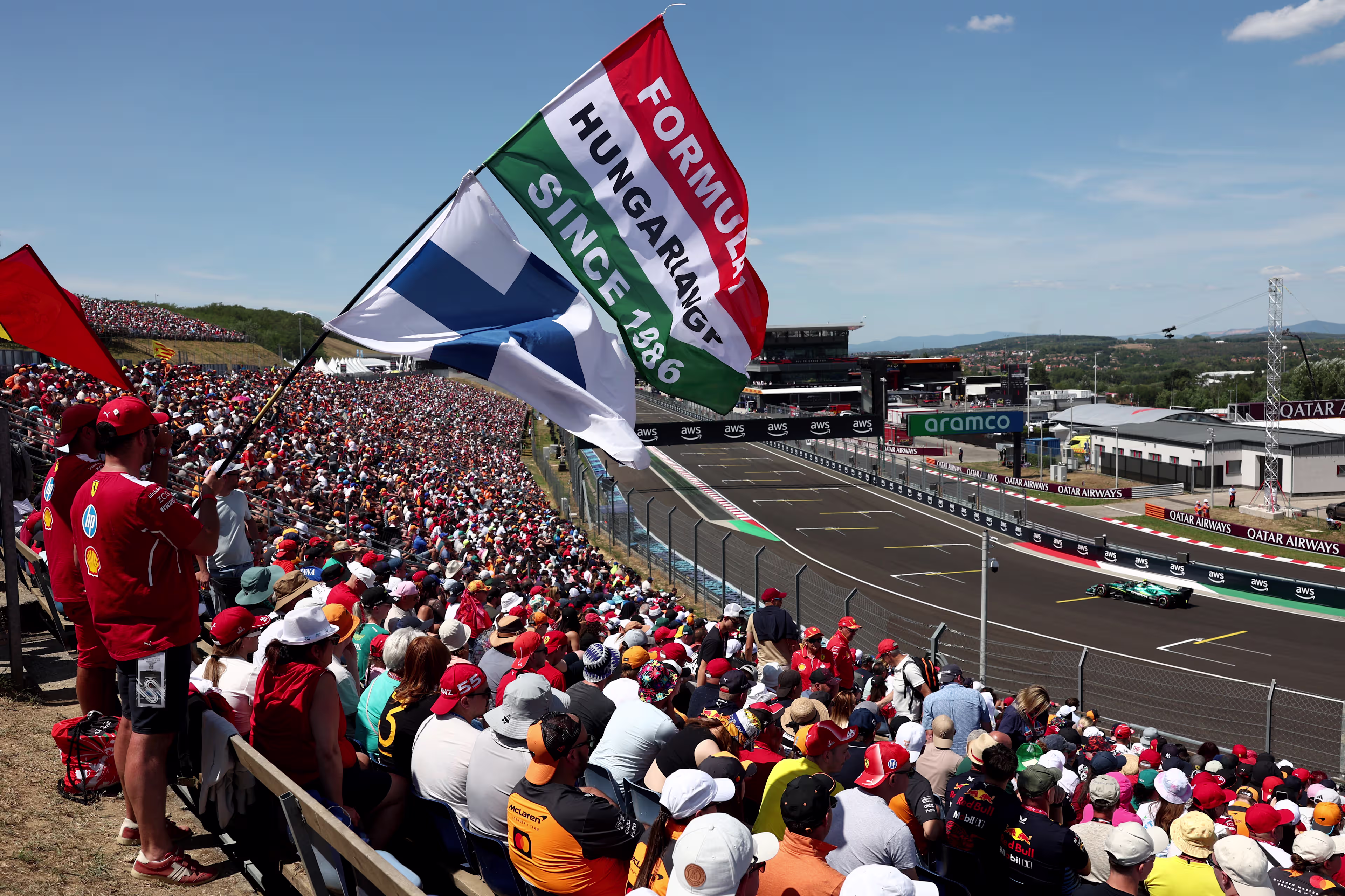 F1 fans in a grandstand at a circuit